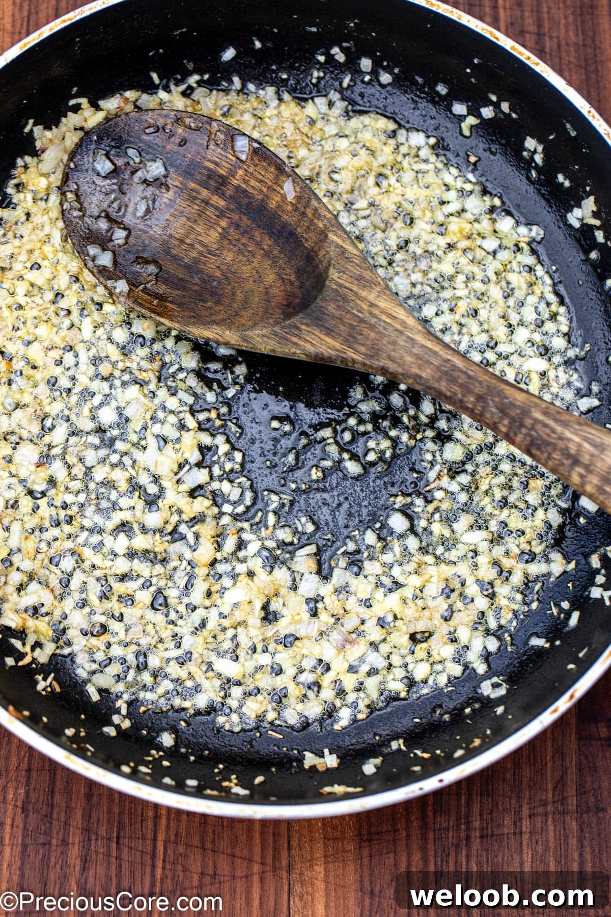 Sautéed shallots and garlic in a skillet.