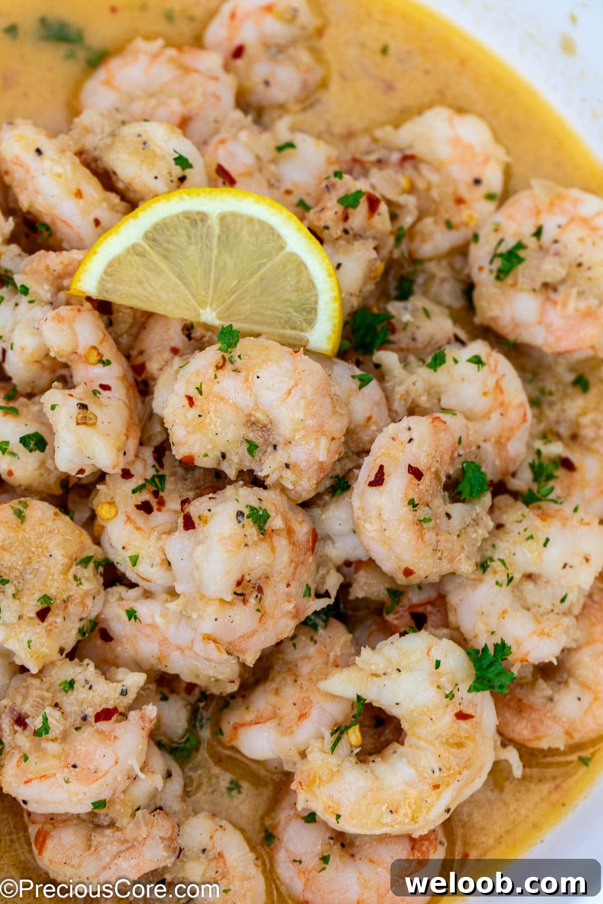 Close up shot of cooked shrimp garnished with a lemon slice.