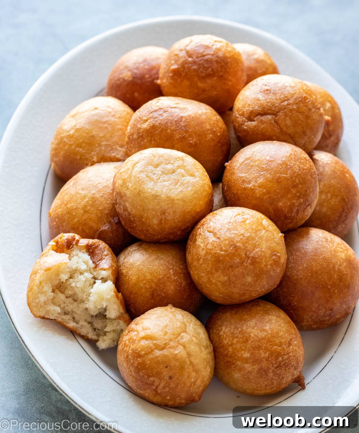 Puff Puff on a tray with one cut to show texture.