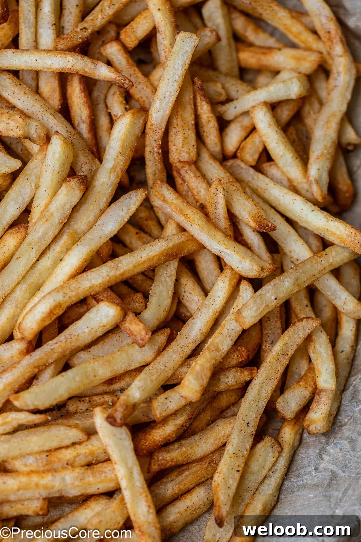 Fries with some seasoning sprinkled on top.