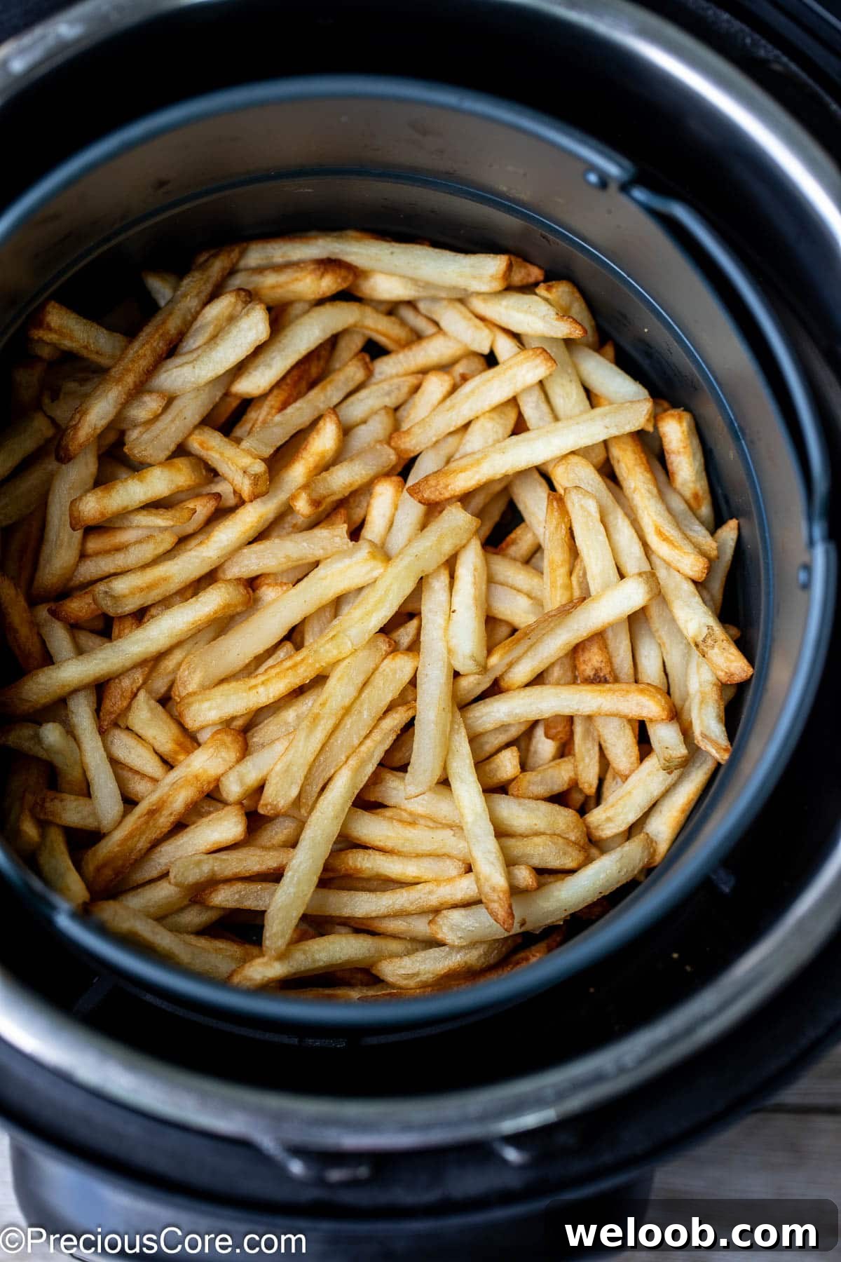 Air fried fries in round air fryer basket.