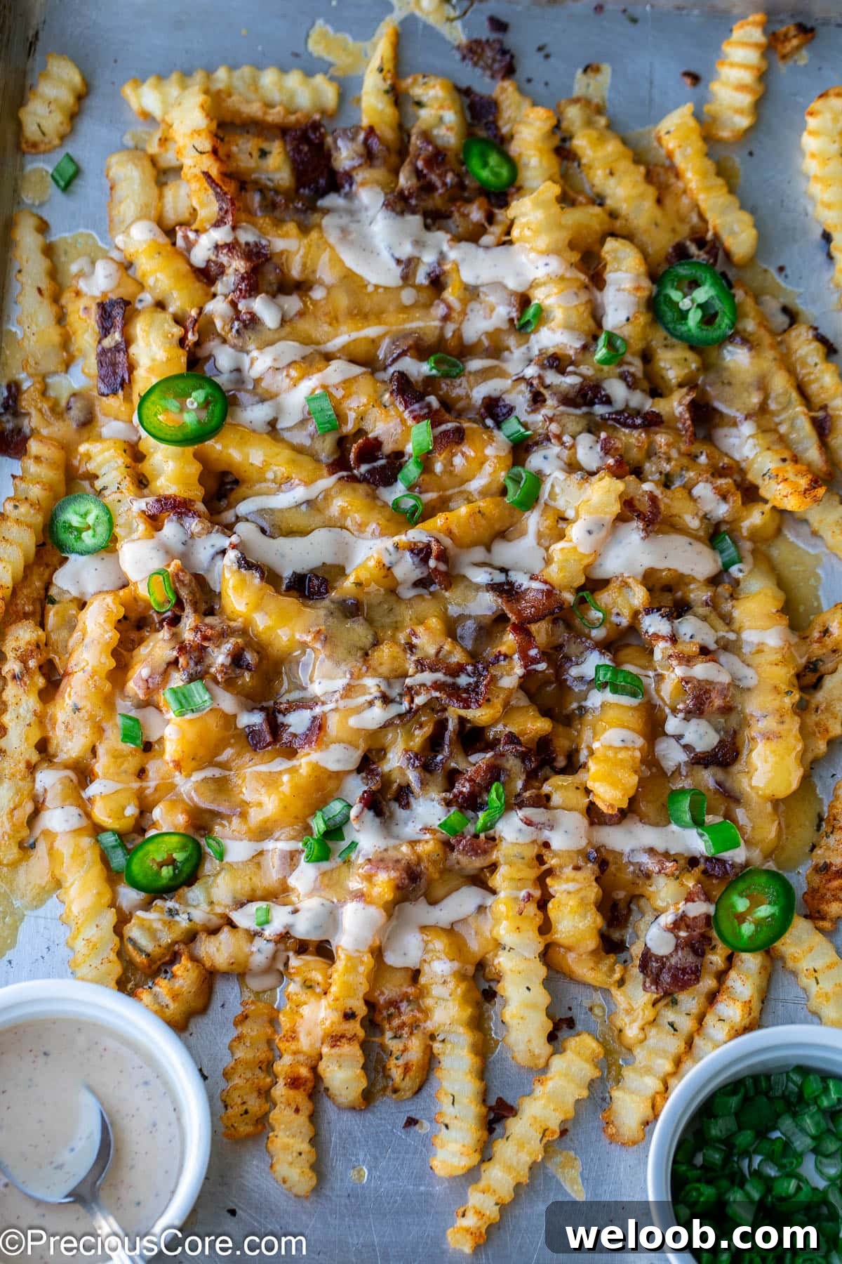 Loaded French Fries on a sheet pan.