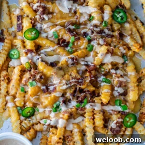 Loaded French Fries on a sheet pan.