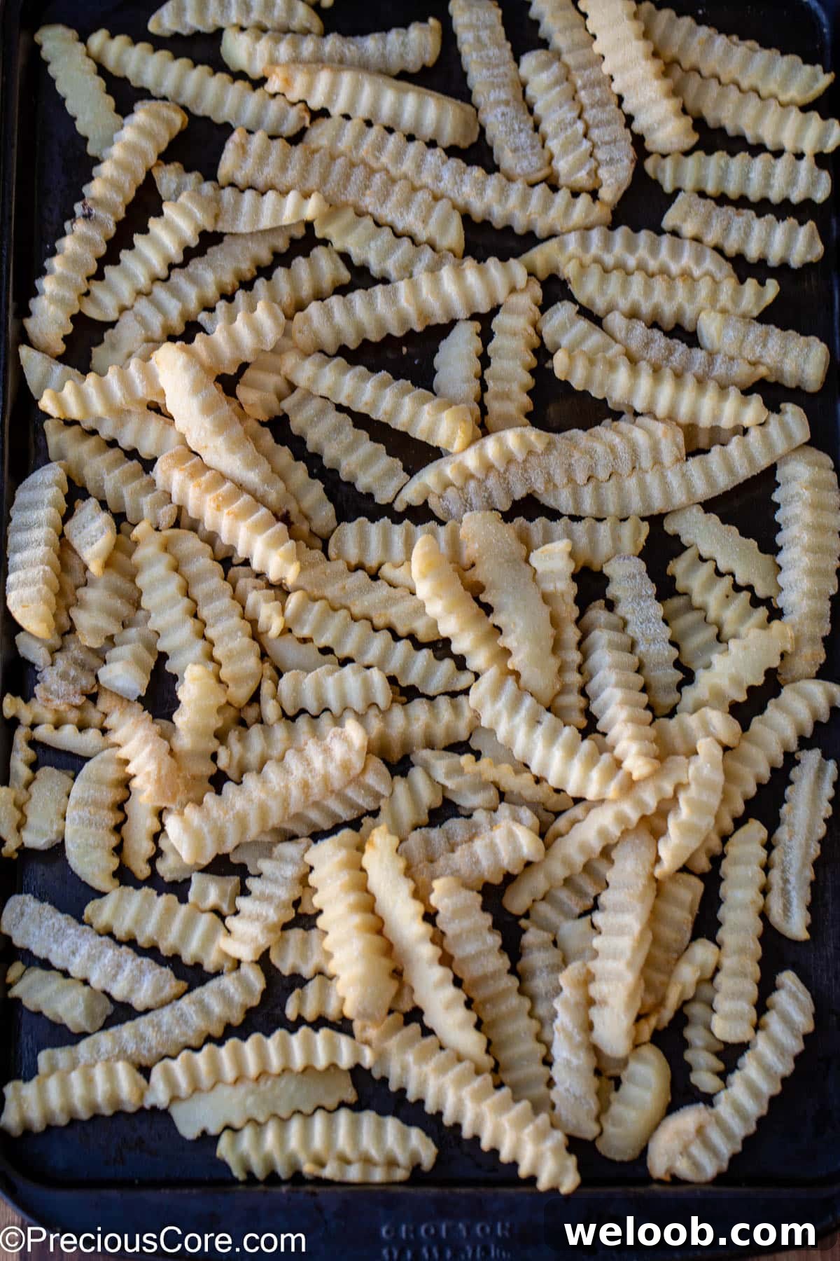 Frozen fries on a sheet pan.