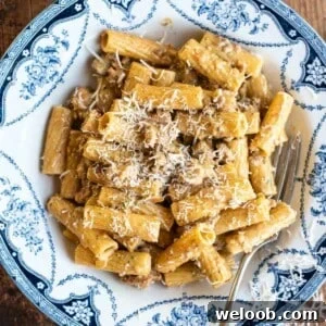 Pasta alla Montecarlo in a blue and white bowl topped with Parmigiano Reggiano.