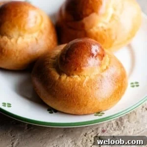 A close up of a Sicilian brioche on a plate that white with green flowers.
