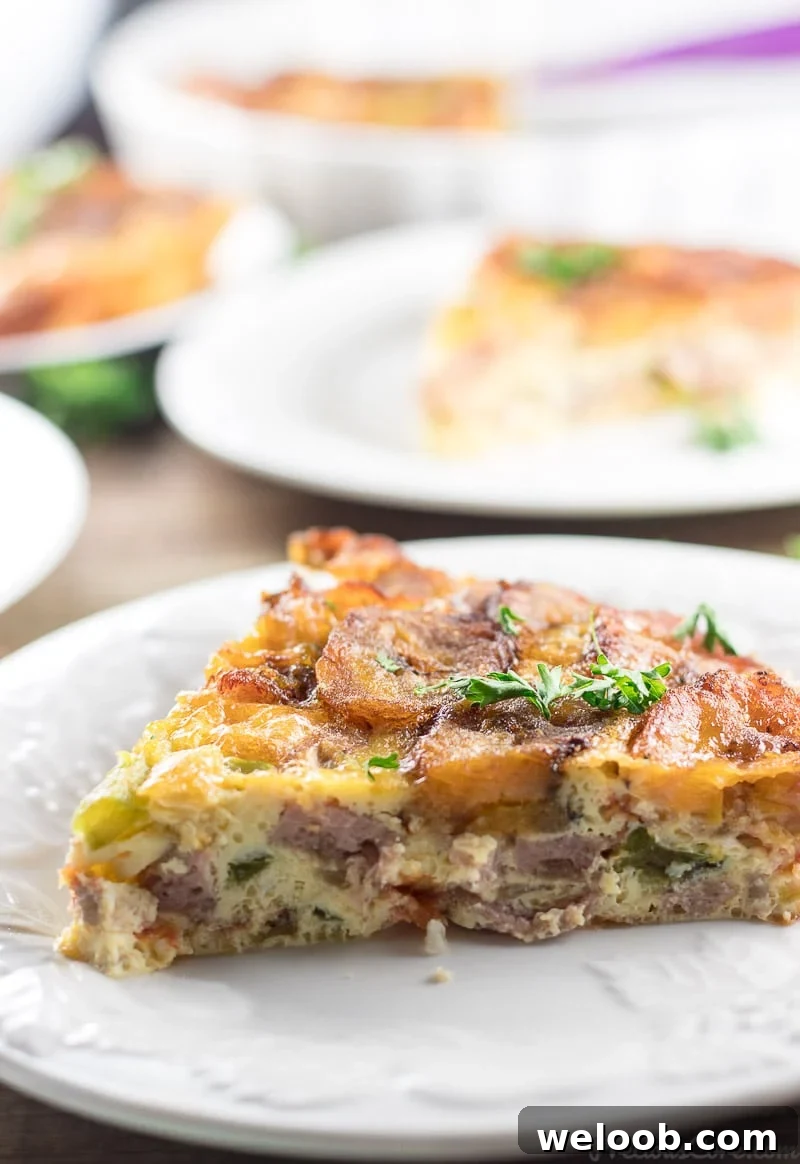 A triangular slice of Plantain Frittata on a white plate.