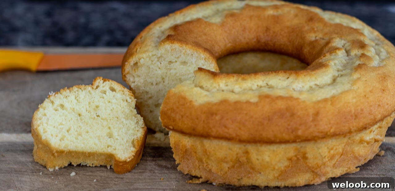 Yogurt cake on cutting board, a slice cut out.