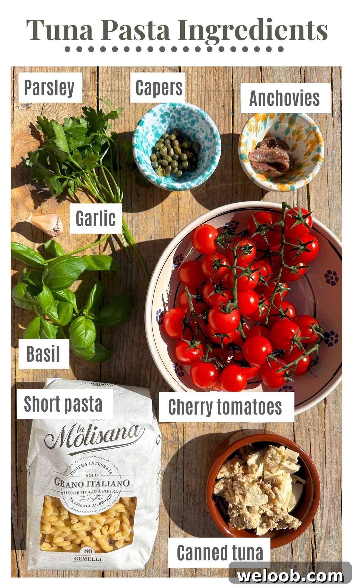 All the ingredients needed to make a tuna pasta sauce in bowls on a rustic wooden surface.