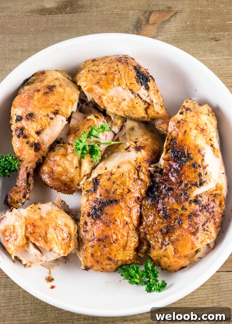 Carved whole chicken on a white platter.