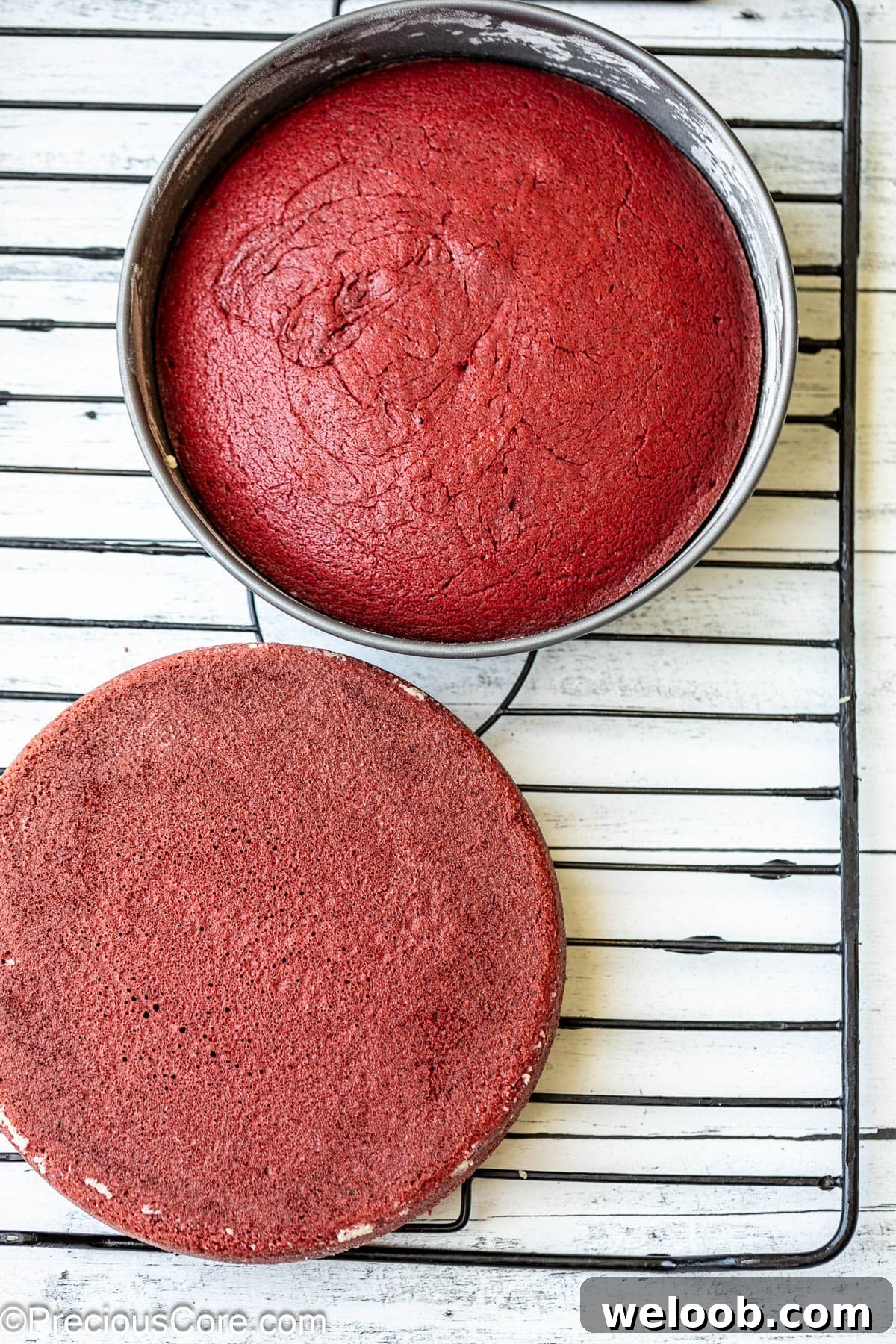 Baked red velvet cake on a cooling rack.