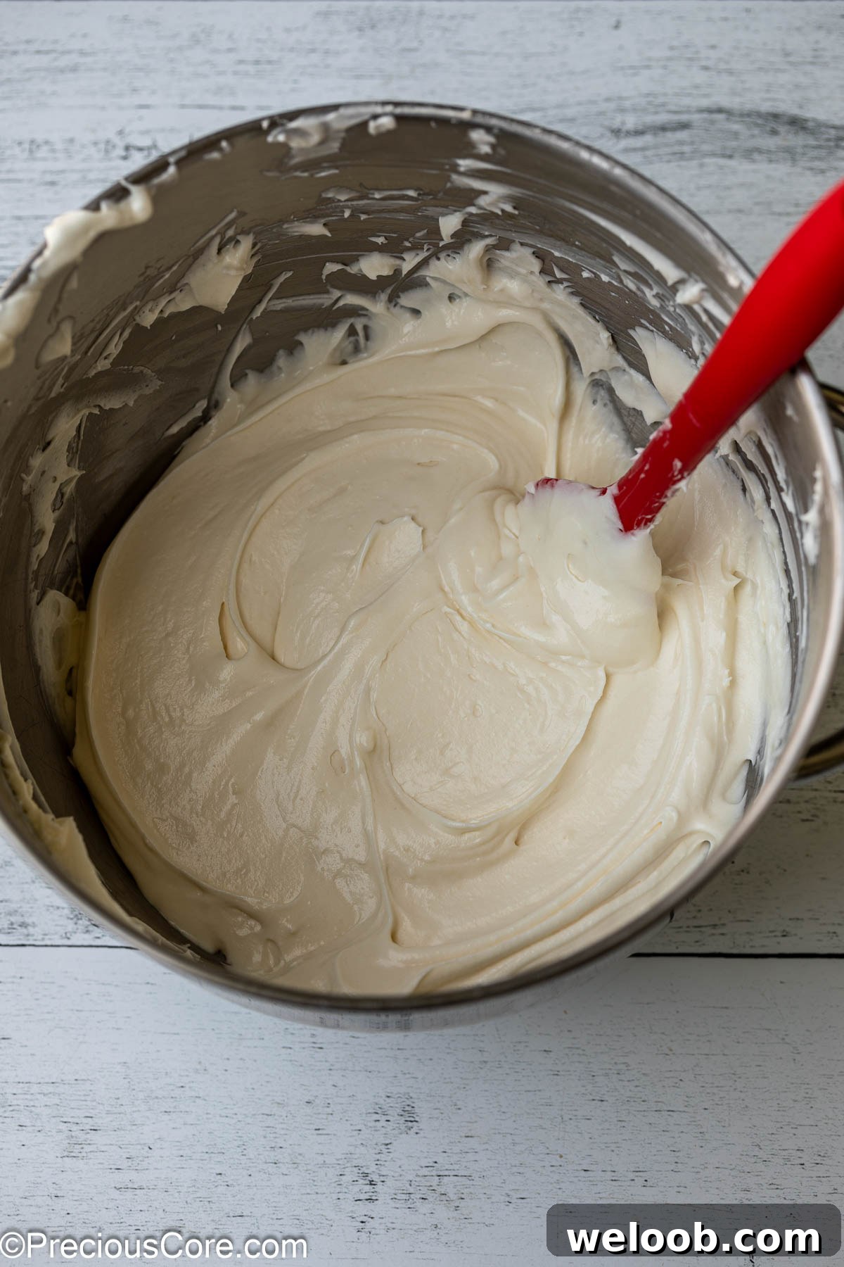 Whipped cream cheese frosting in a bowl.