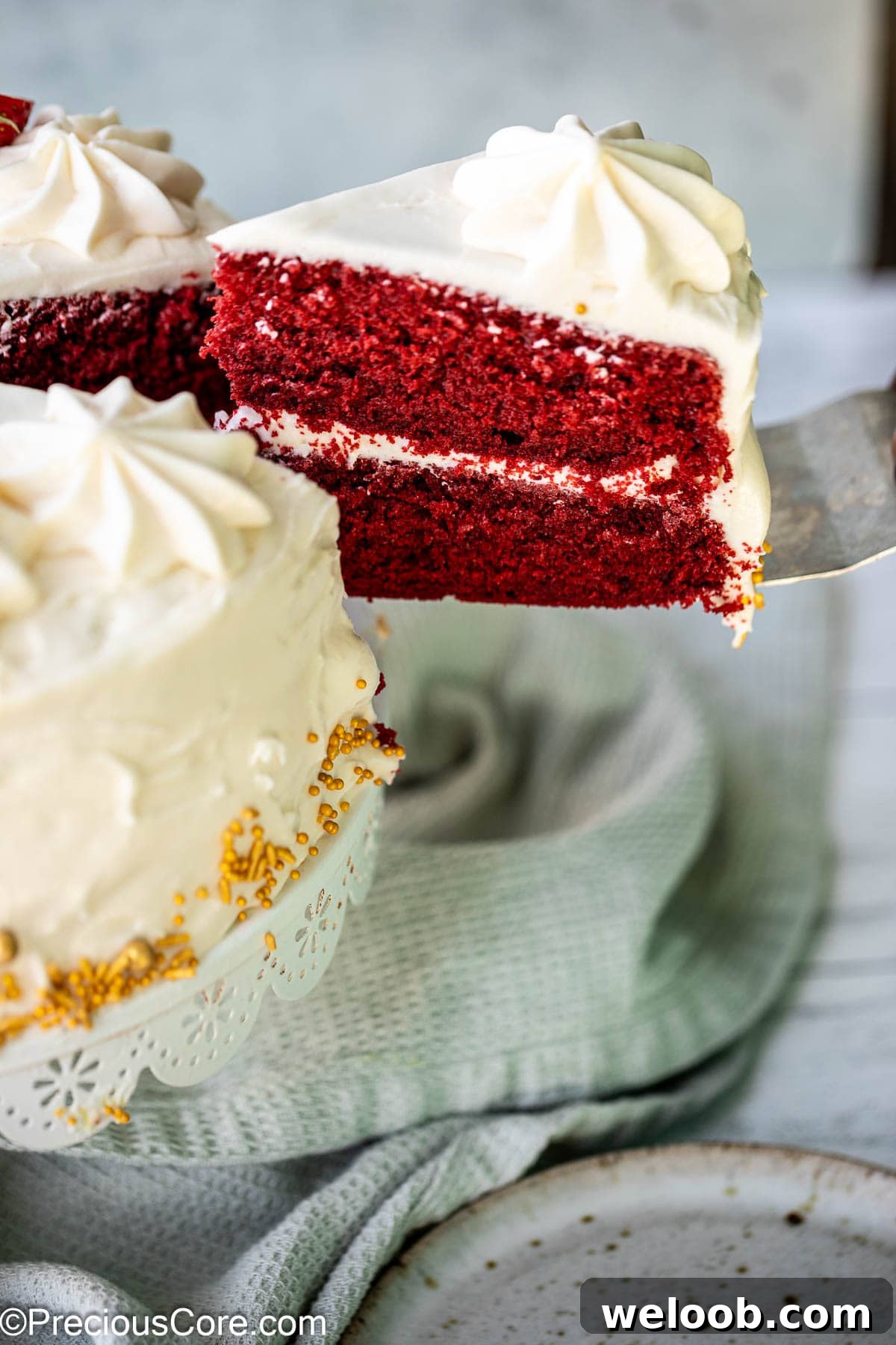 Slice of red velvet cake on a cake shovel.
