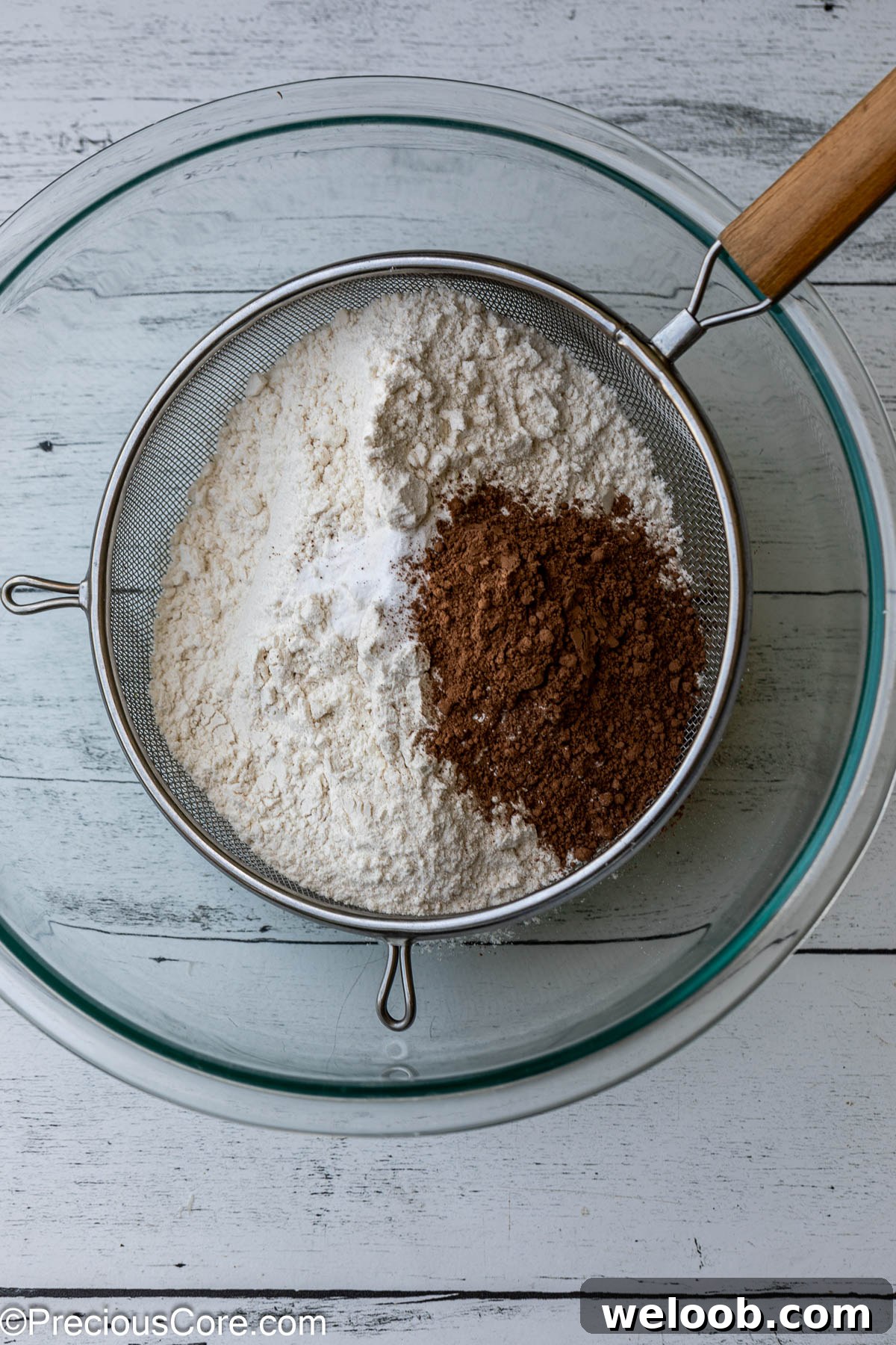 Sifting dry ingredients for cake.