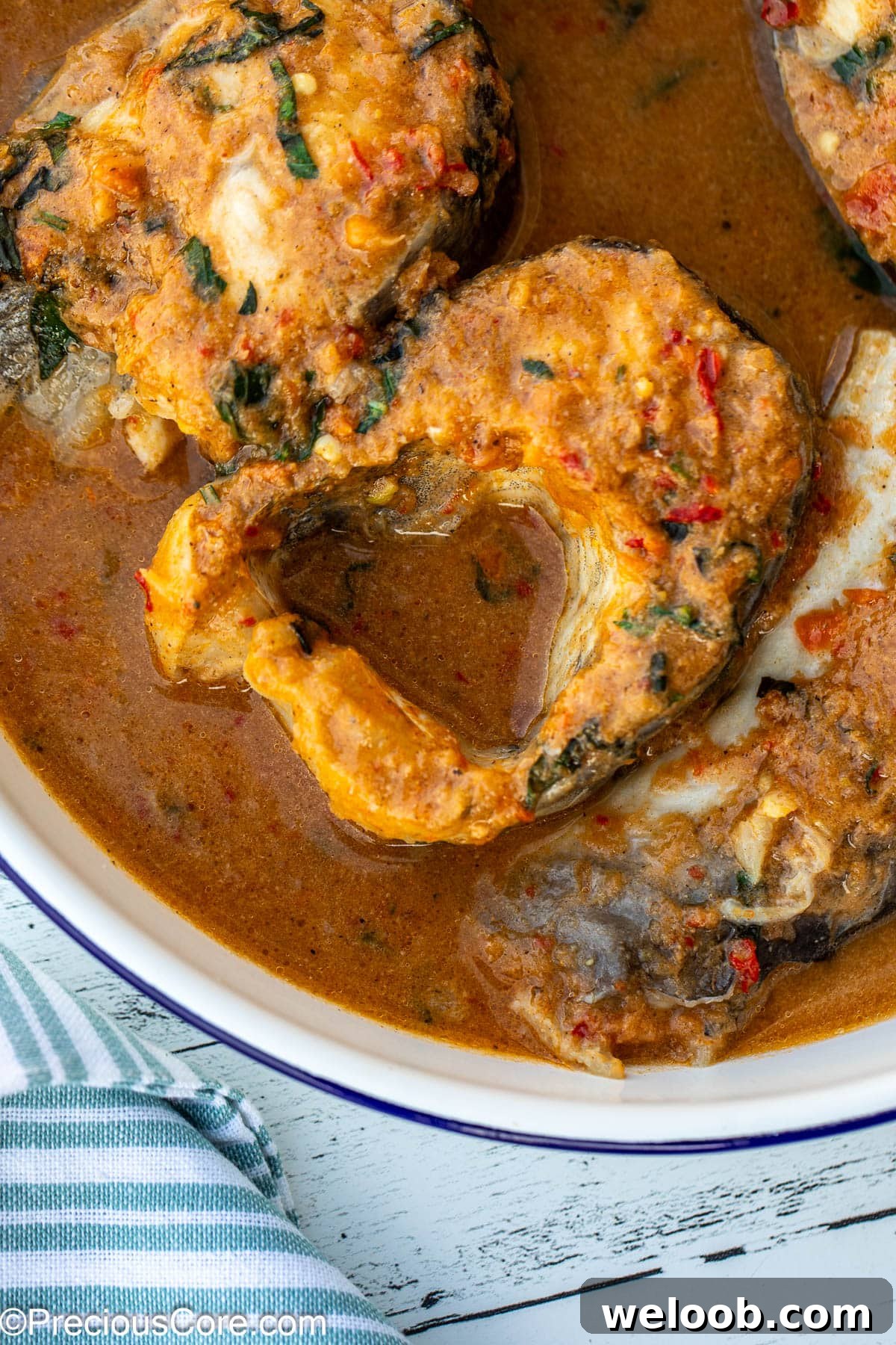Close-up of fish steaks in a broth.