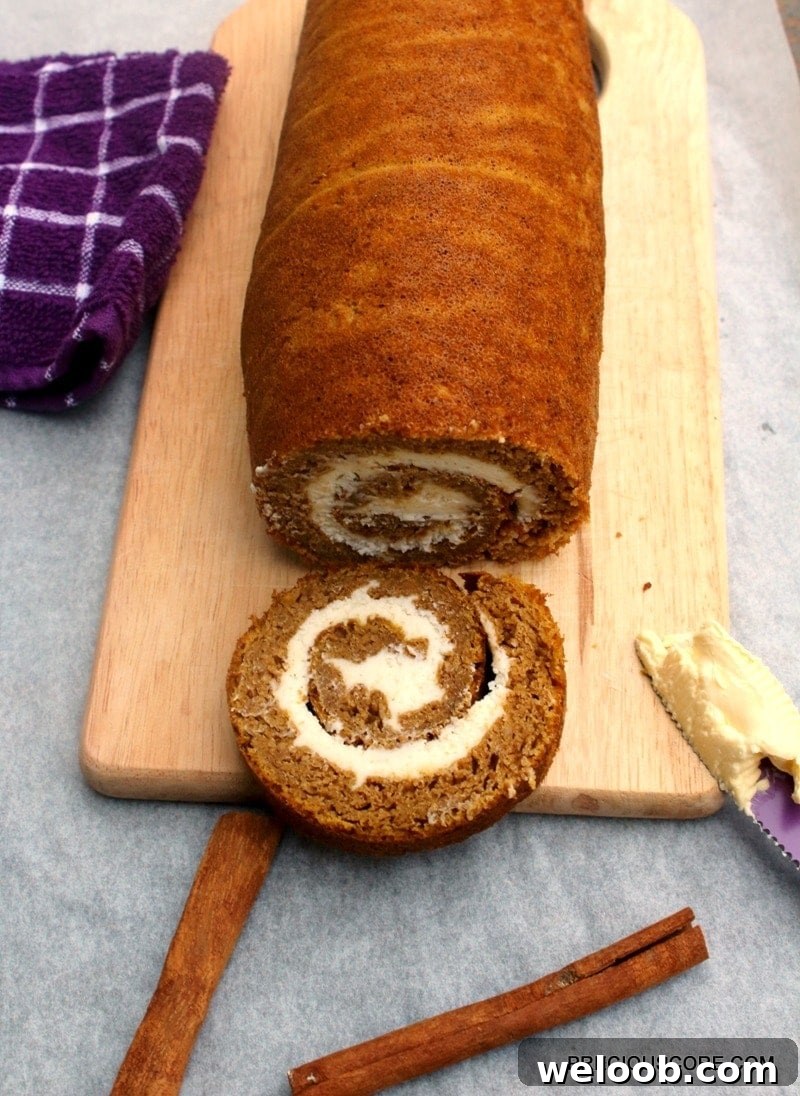 A Pumpkin Roll Cake on a chopping board