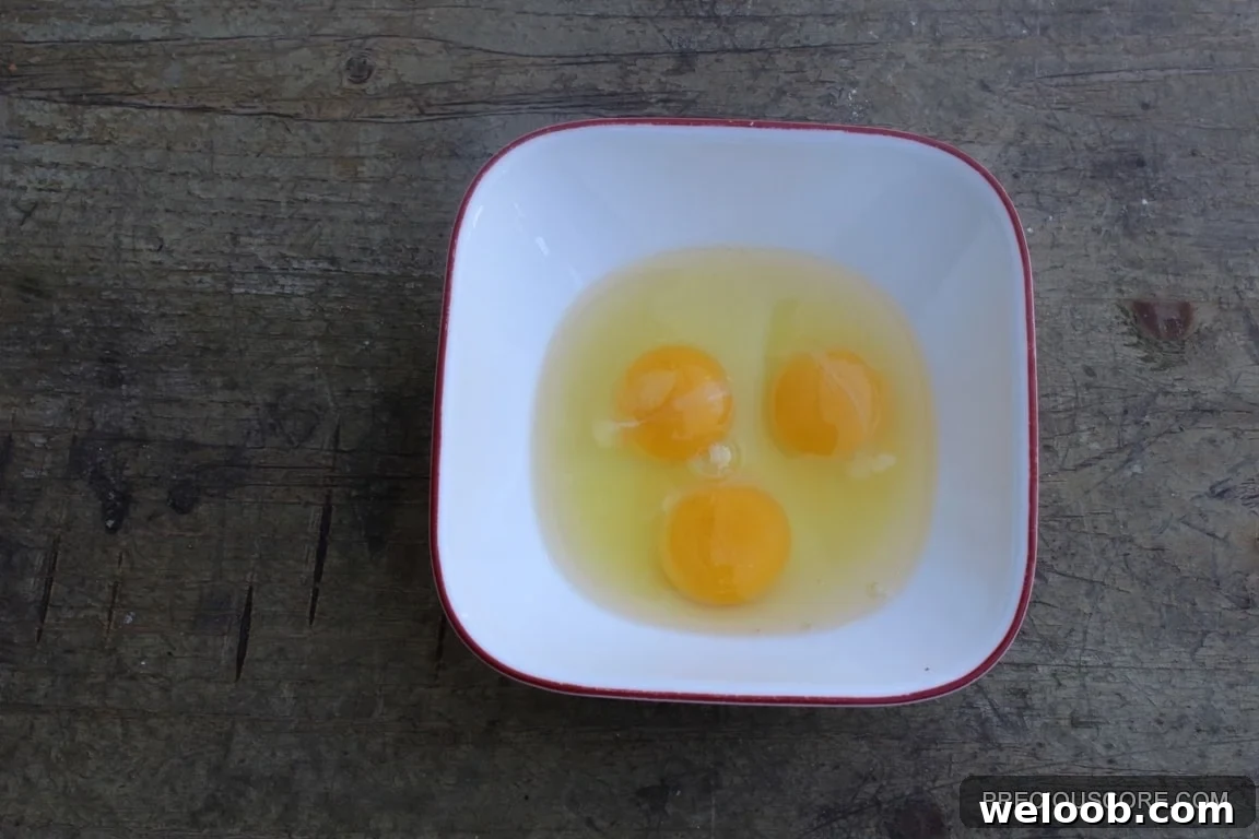 Three eggs in a bowl.