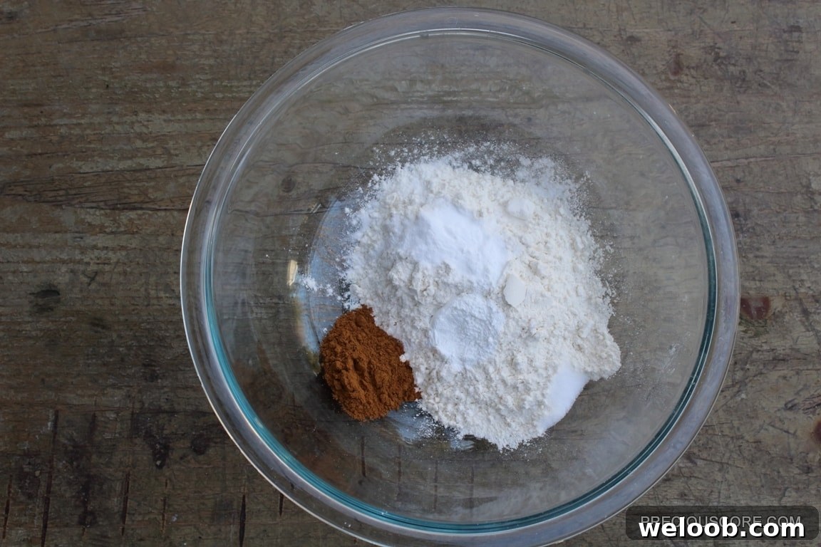 Dry cake ingredients in a glass mixing bowl.