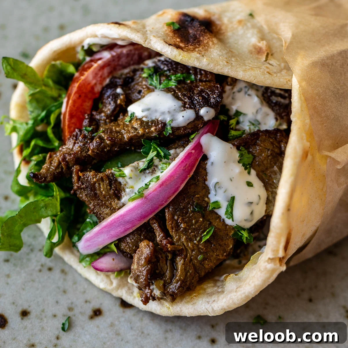 Close up image of beef shawarma wrap.