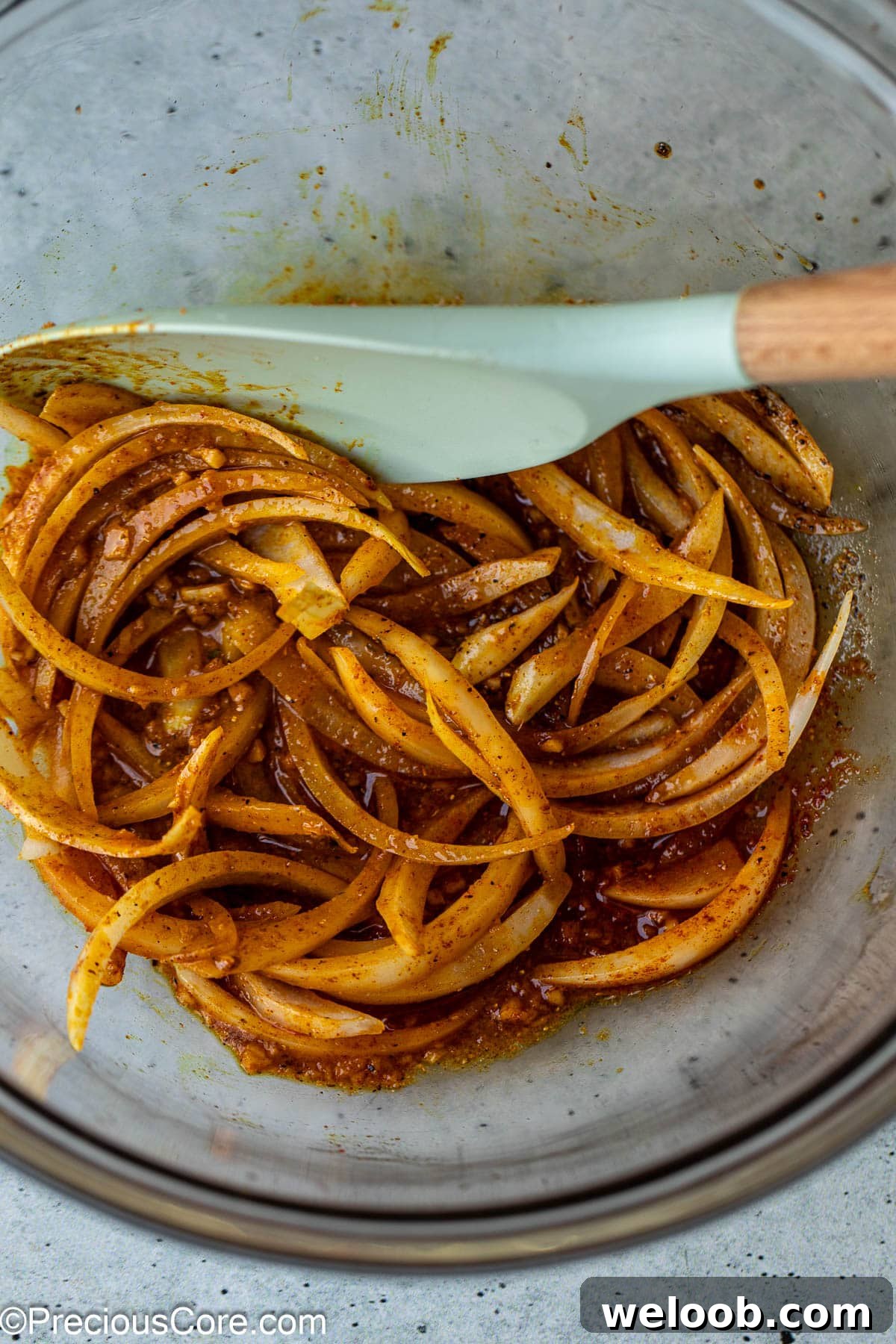 Onions and marinade ingredients in bowl.