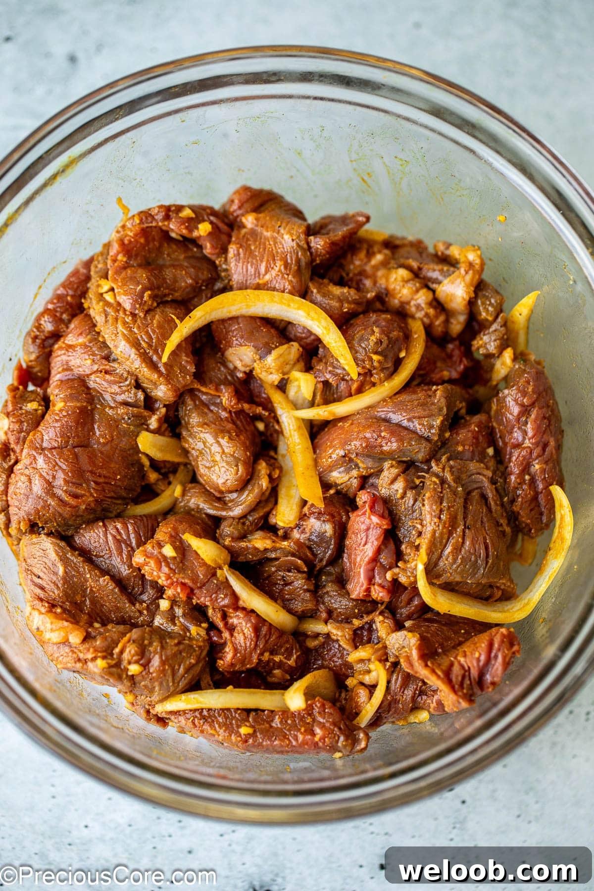 Marinating beef for beef shawarma in a bowl.