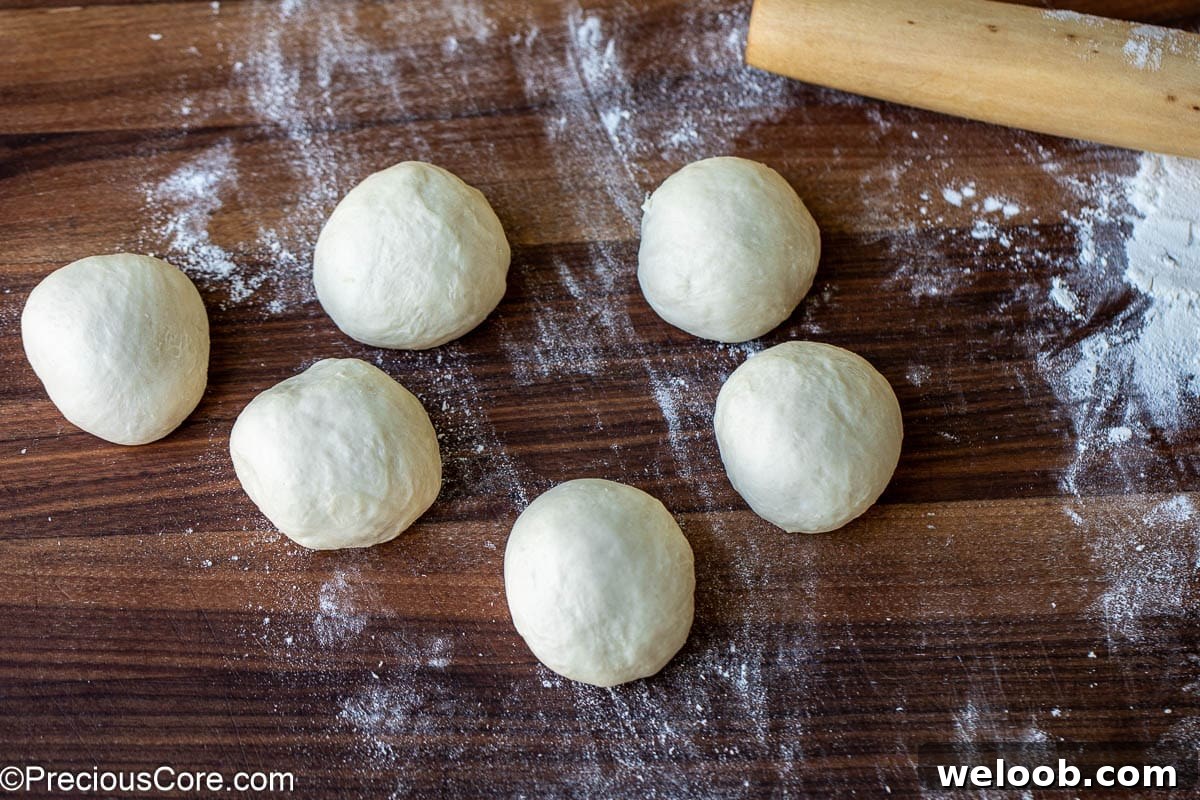 Divided dough shaped into 6 balls.