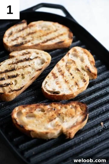 Slices of crusty bread getting char-grilled on a griddle pan.