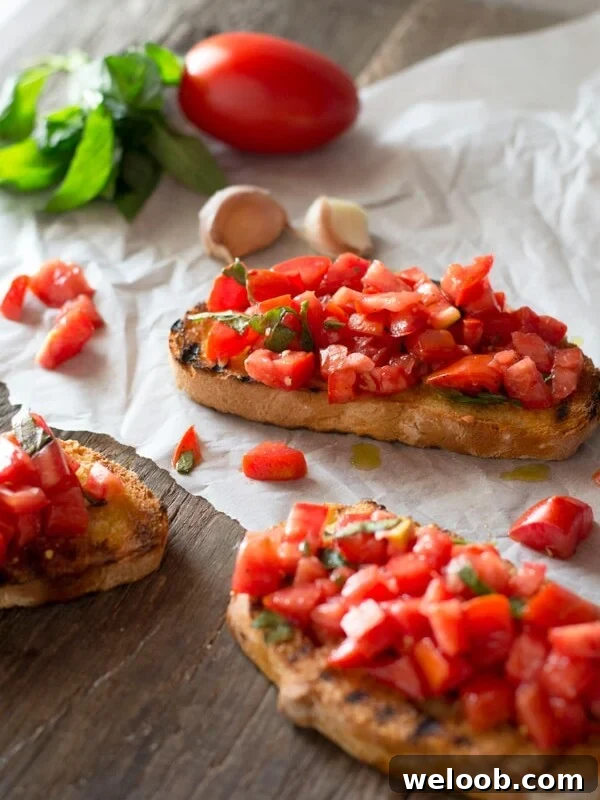Bruschetta al pomodoro - classic Italian tomato bruschetta recipe made with ripe, juicy tomatoes, fresh basil and extra virgin olive oil. Served on char grilled, garlic toasts, this one is always a winner! Inside the rustic kitchen
