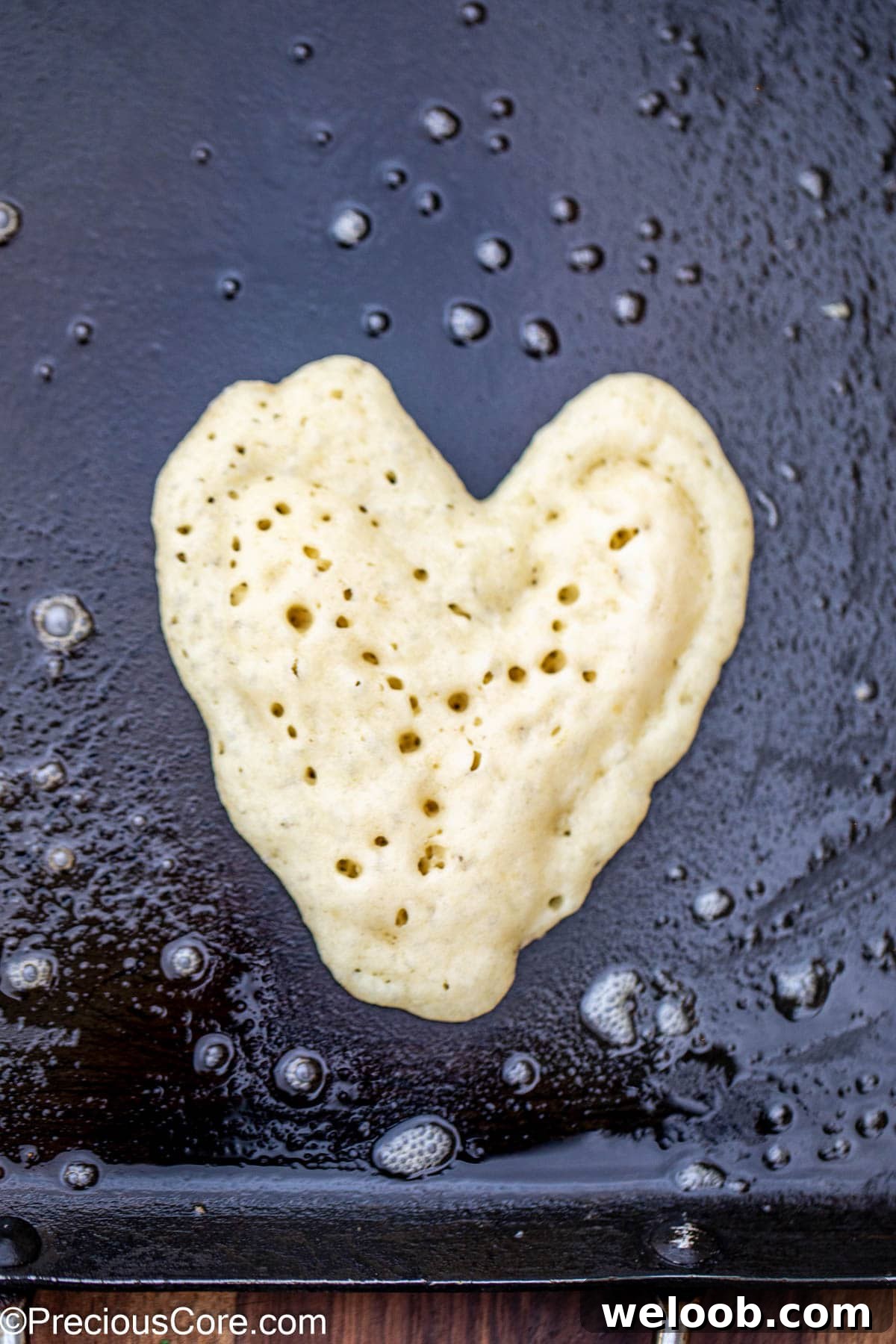 Heart pancake on a griddle.