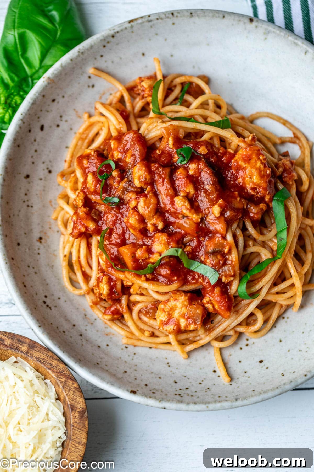 Pasta tossed with red sauce in a bowl.