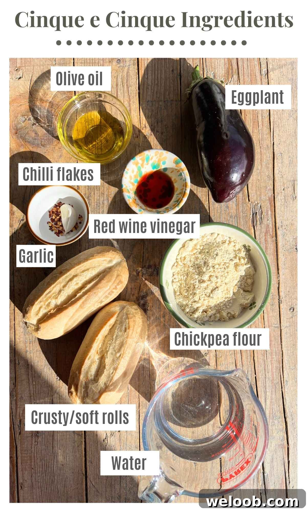 All the ingredients needed to make a 5x5 Livornese sandwich sitting on a rustic wooden background.
