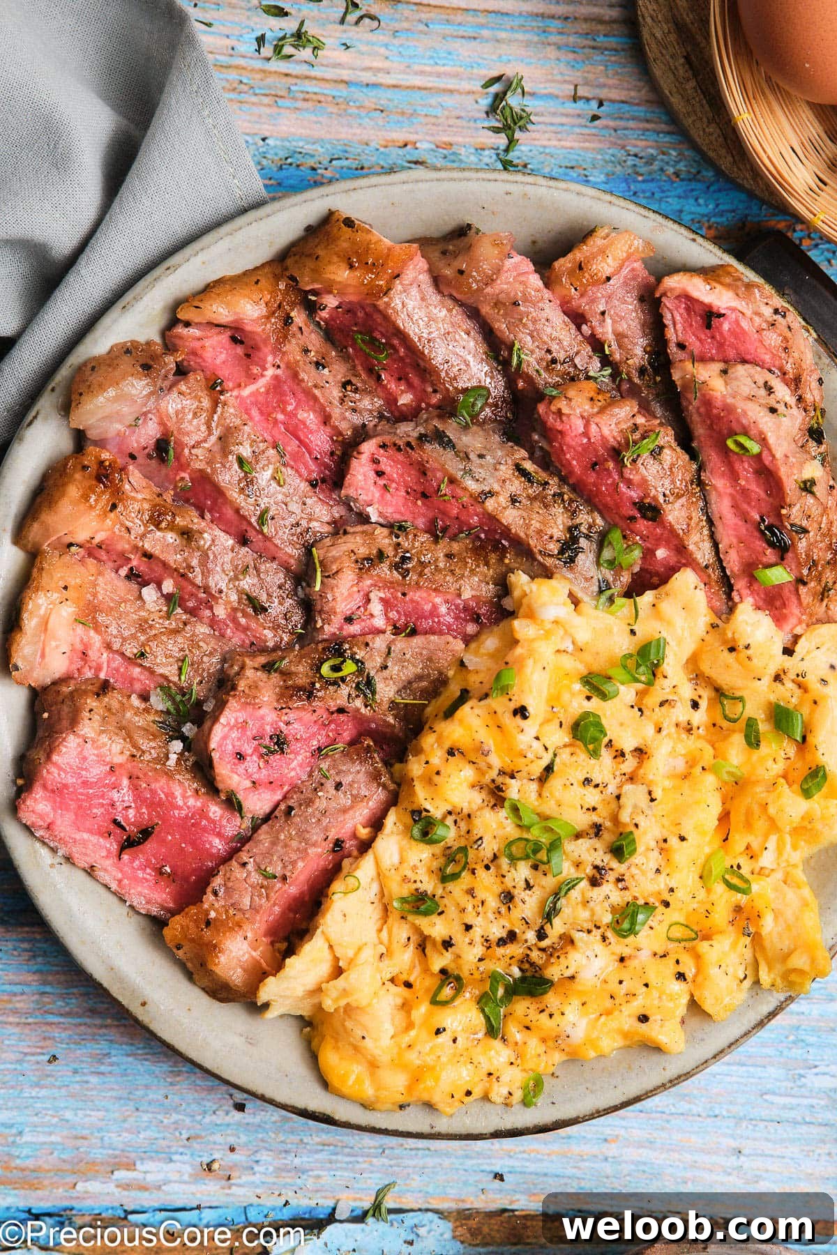 Close-up of Steak and Scrambled Eggs on a plate.
