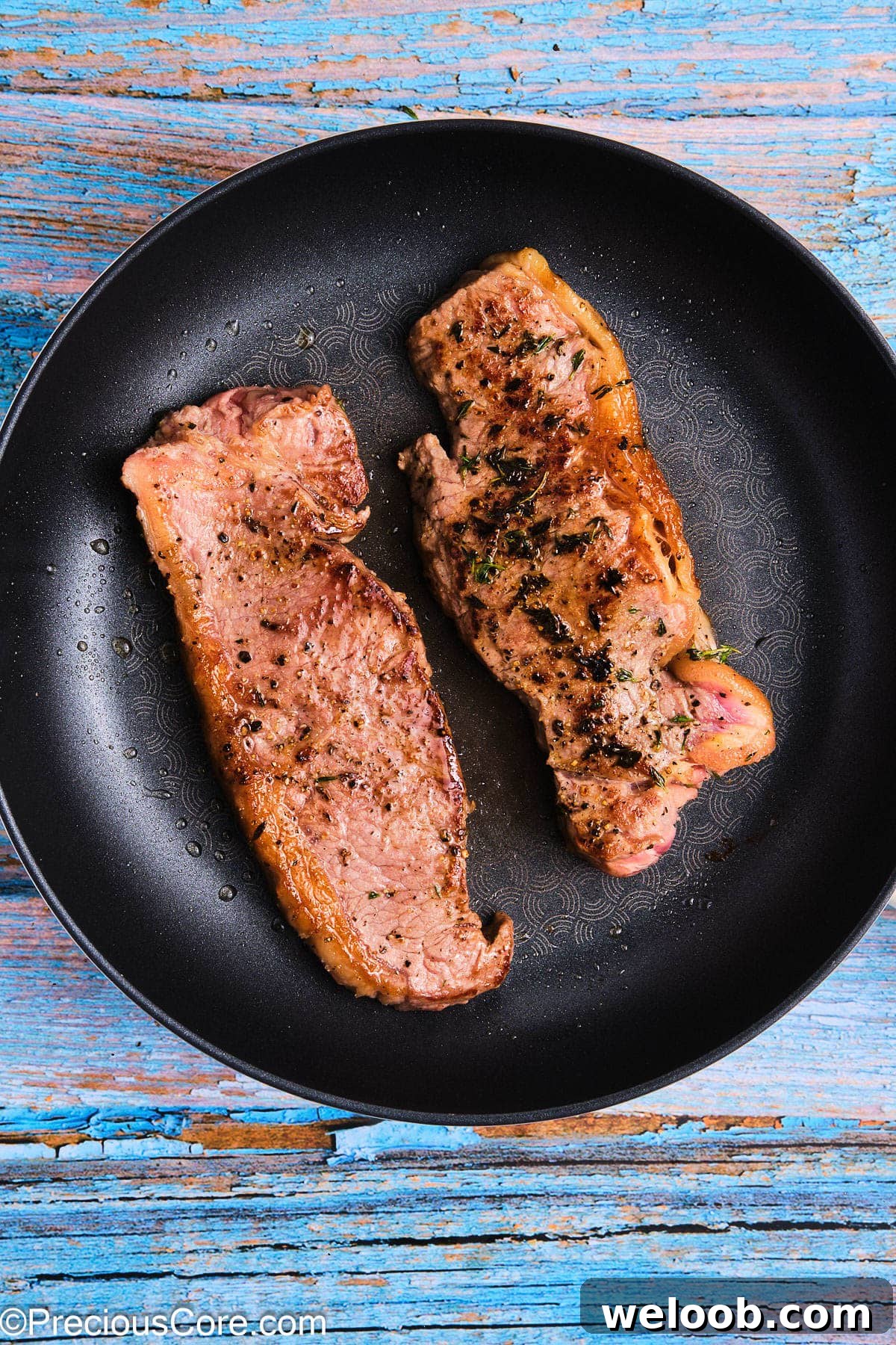 Seared steaks in a skillet.