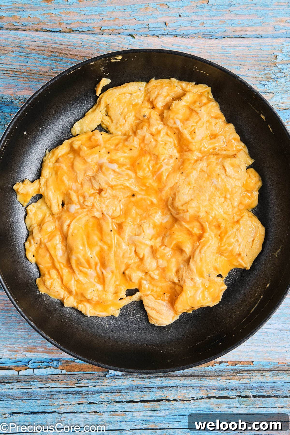 Soft scrambled eggs in a skillet.