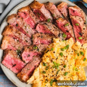 Close-up of Steak and Scrambled Eggs on a plate.