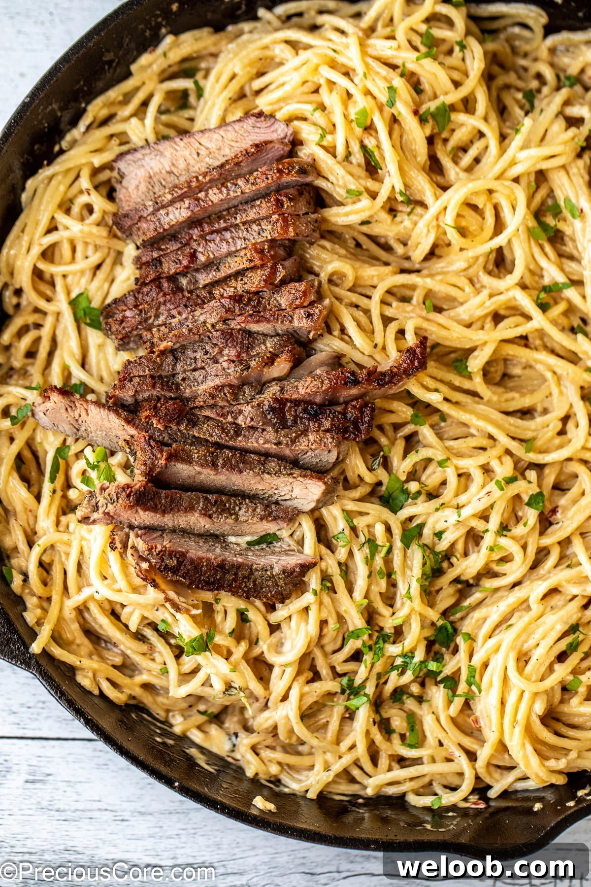 Finished Steak and Pasta dinner in a skillet.