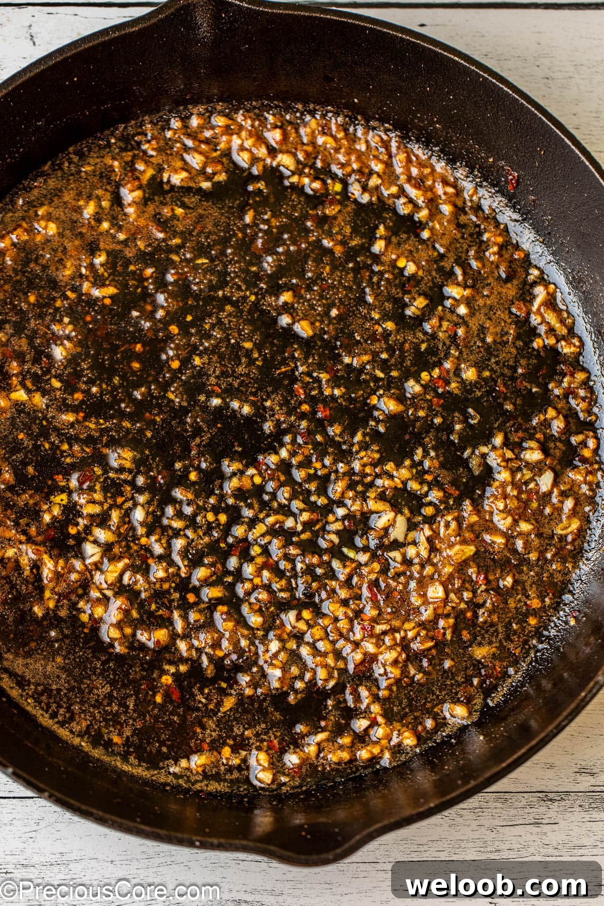 Melted butter and fresh garlic in a skillet.