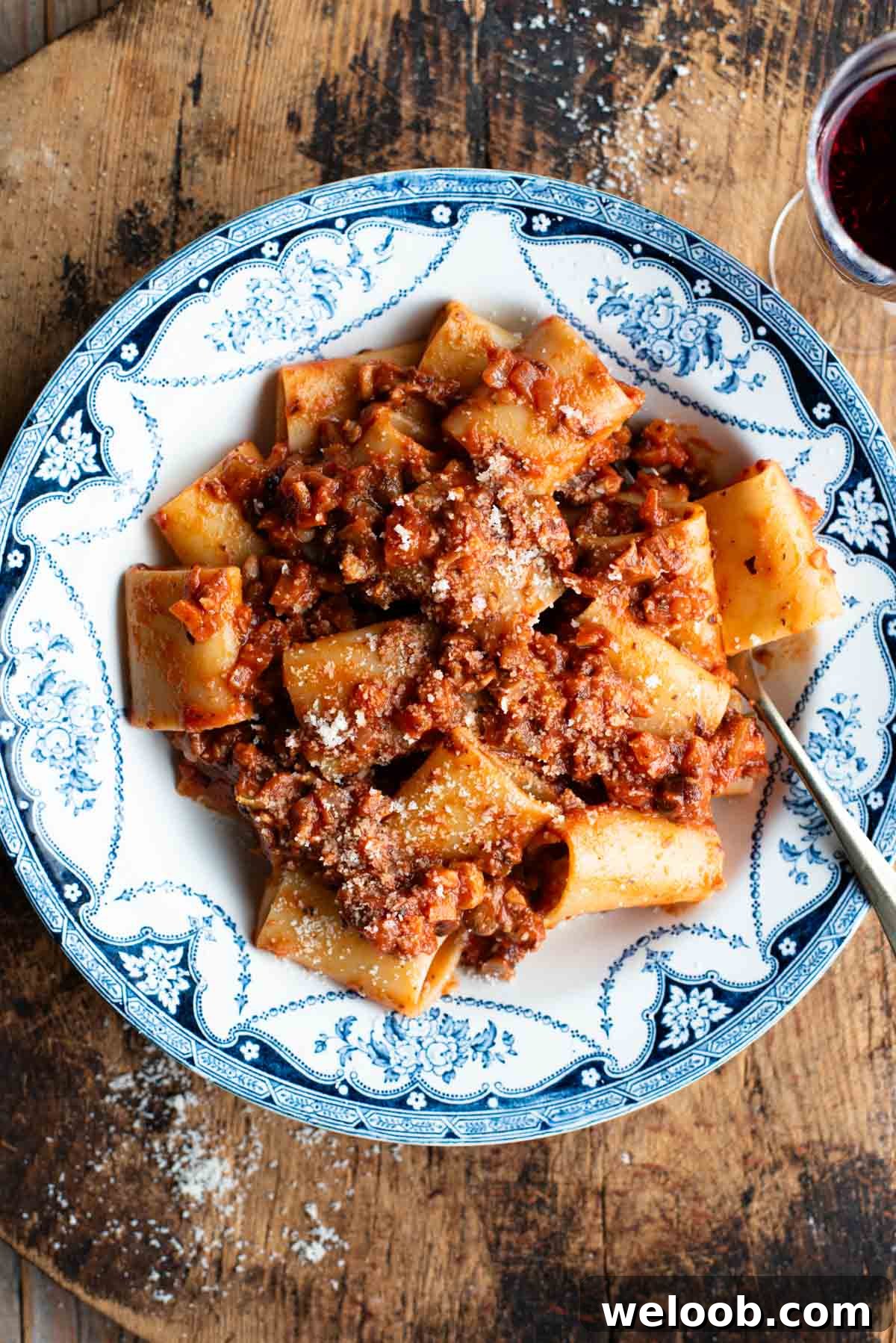 A blue and white vintage style bowl with paccheri and hazelnut ragu.