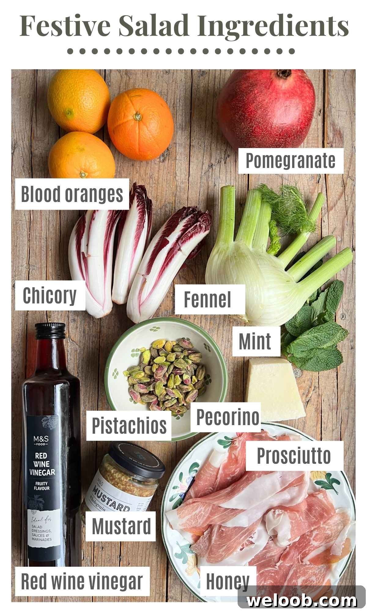 All the ingredients for a festive salad laying on a rustic wooden surface. The labels read: blood oranges, pomegranate, fennel, chicory, red wine vinegar, mustard, mint, honey, prosciutto, pistachios and pecorino.