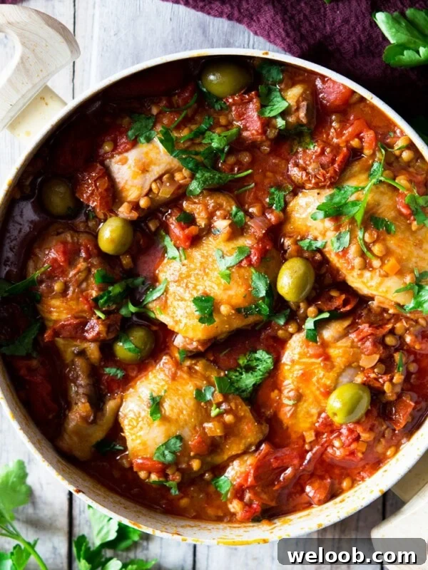 Braised Chicken with Pancetta, White Beans and Fresh Sage 7 a close up of one-pot chicken with olives, tomatoes and olives