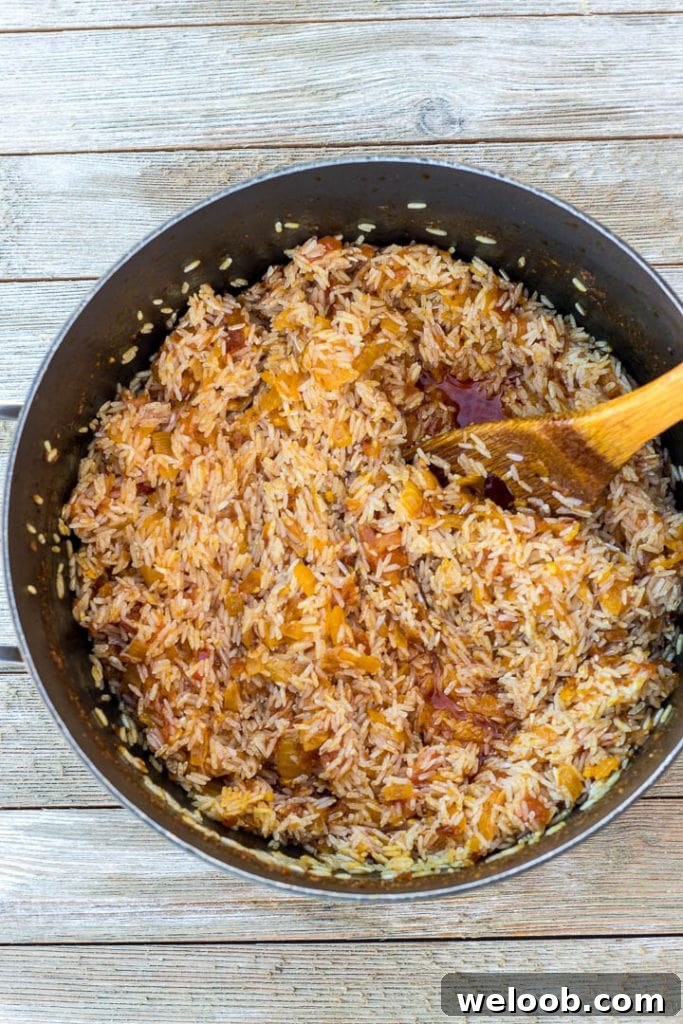 washed rice in pot for palm oil jollof rice
