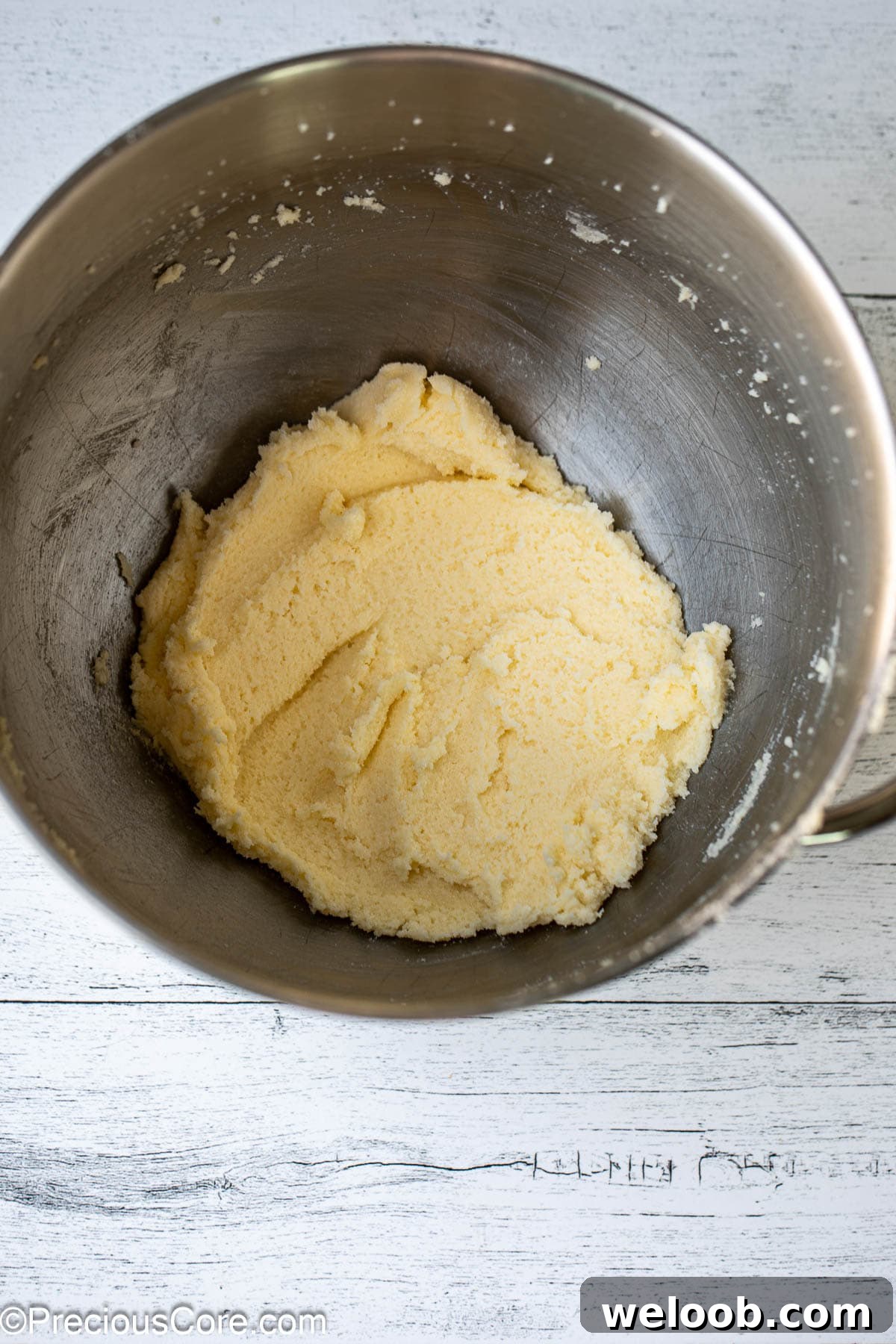 Mixed butter and sugar in a bowl.