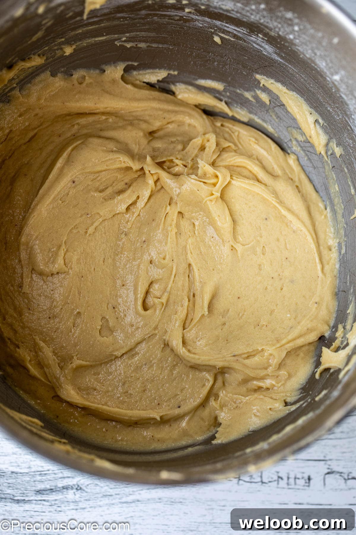 Cake batter in a metal bowl.