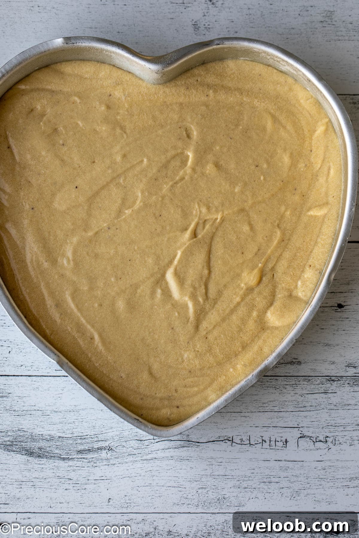 Cake batter in a heart-shaped pan.