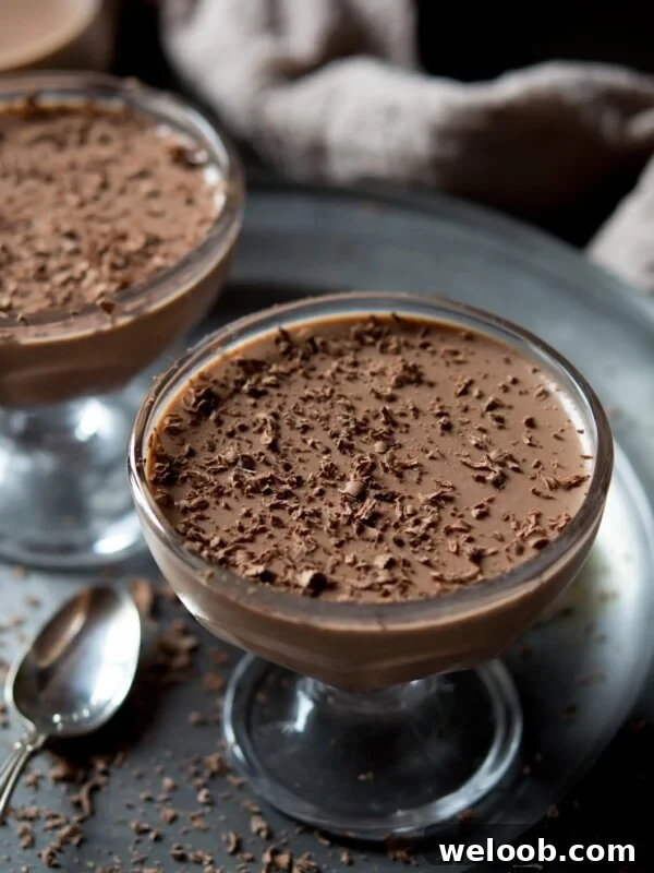 choclate panna cotta in a glass with grated dark chocolate on top