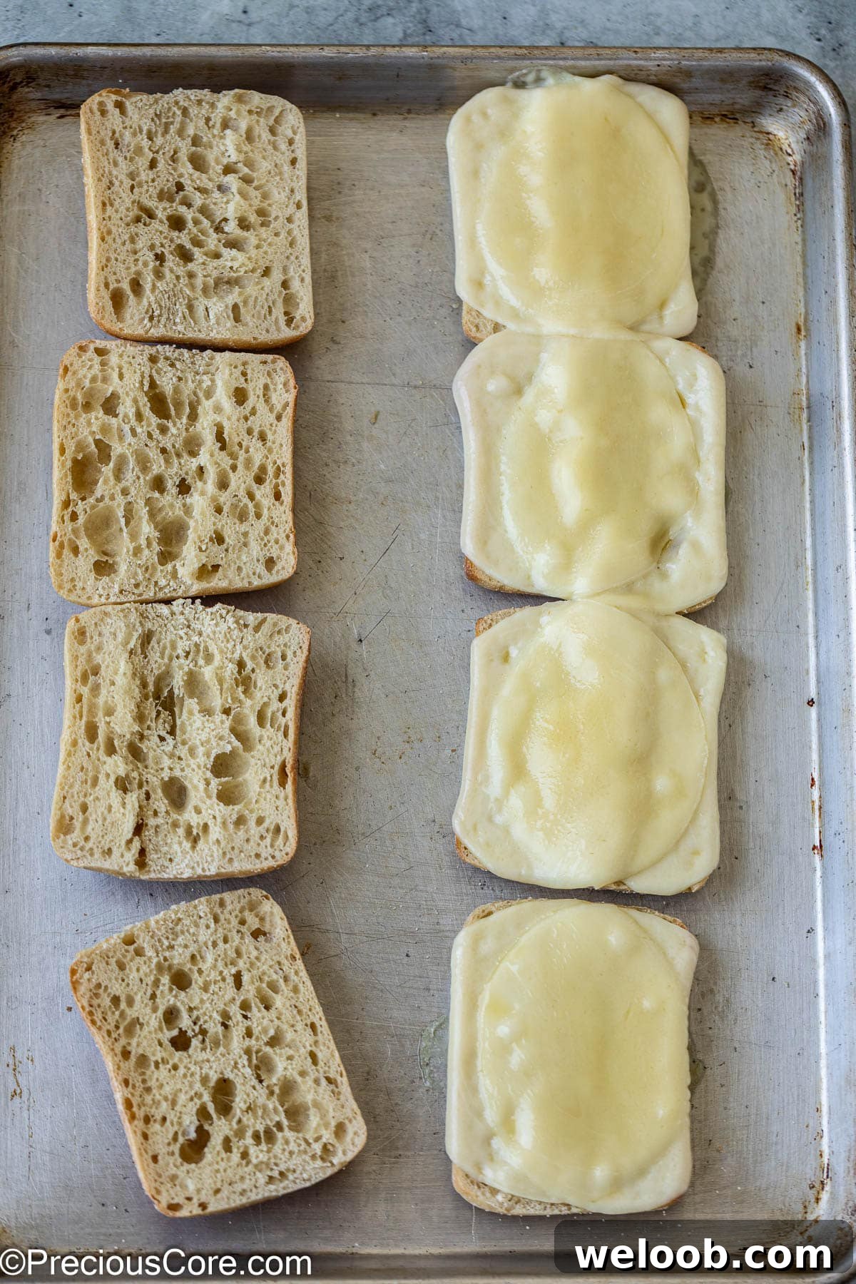 Toasted bread with melted cheese slices.