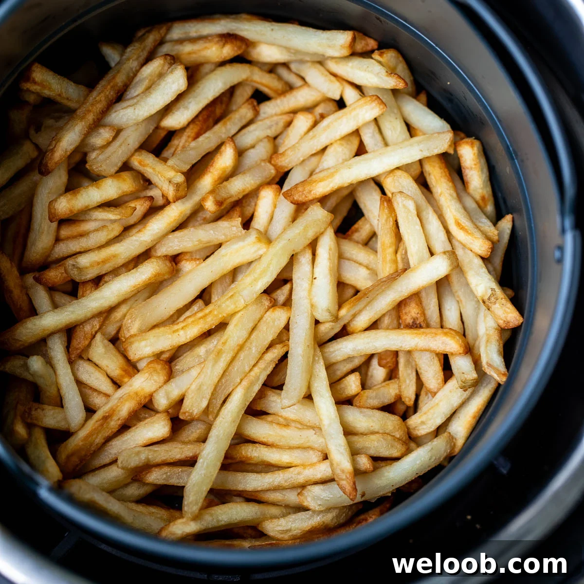 Square image of frozen fries cooked in air fryer.