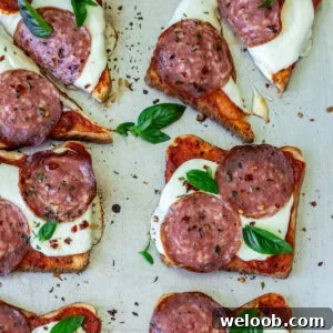 Pizza toast garnished with fresh basil.