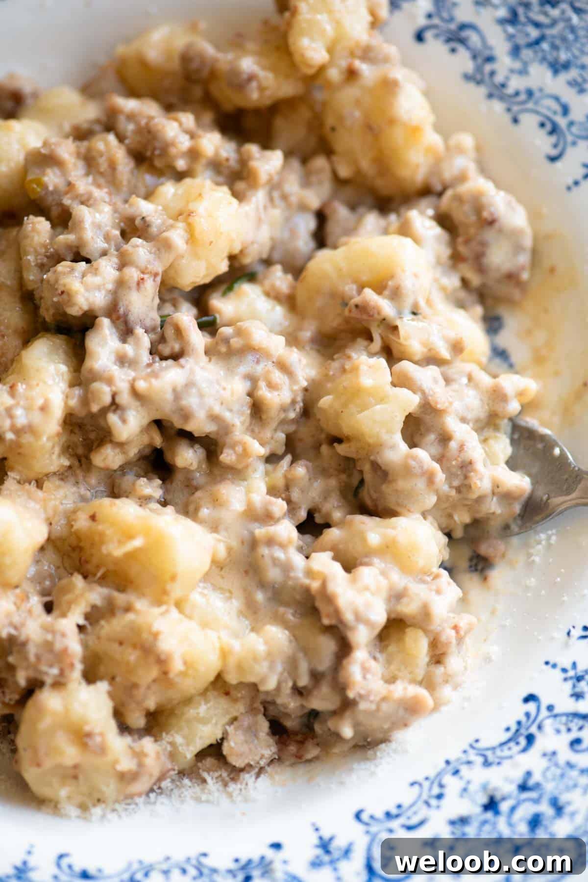 Creamy Sausage Ragu Gnocchi Recipe for Comfort Dinner 4 A close up of gnocchi with a creamy white sausage sauce.