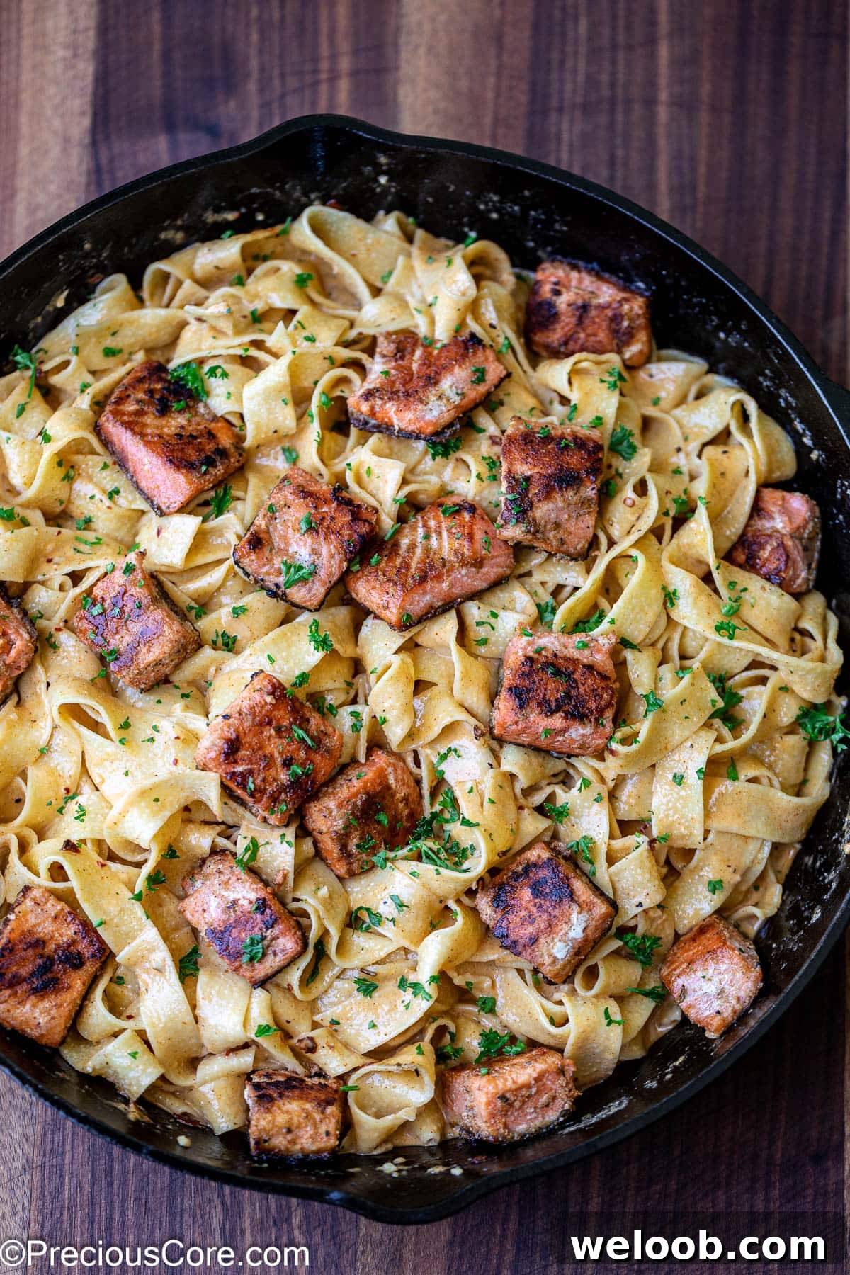 Cajun pasta with salmon pieces added.